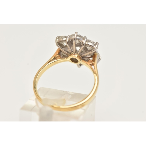 14 - AN 18CT WHITE AND YELLOW GOLD DIAMOND CLUSTER RING, set with a principal round brilliant cut diamond... 