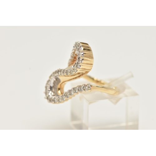 2 - A MODERN DIAMOND DRESS RING, the ring is of an abstract design, set with graduating tapered baguette... 