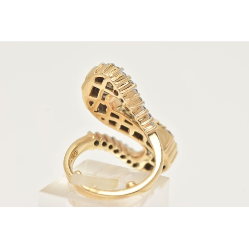 2 - A MODERN DIAMOND DRESS RING, the ring is of an abstract design, set with graduating tapered baguette... 