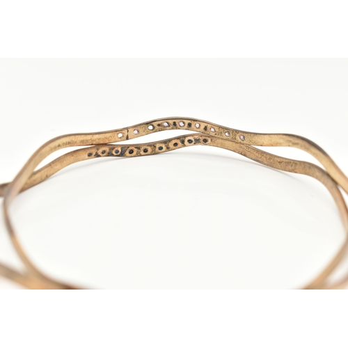 27 - A PAIR OF MATCHING 9CT GOLD BANGLES, wave design bangles, one set with nine star set blue spinel's, ... 