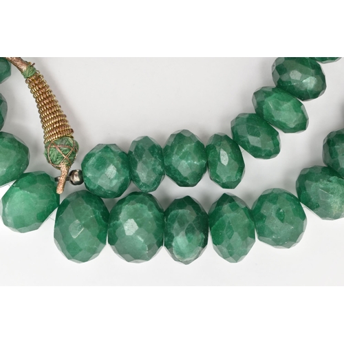 41 - A SINGLE STRAND OF HEAVILY TREATED, FACETED GREEN HARDSTONE BEADS, oval to round in shape, not unifo... 