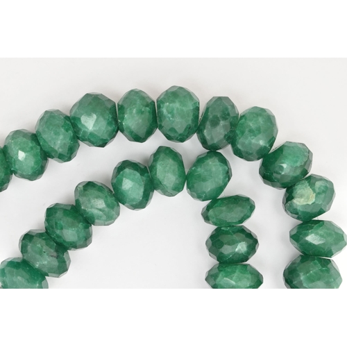 41 - A SINGLE STRAND OF HEAVILY TREATED, FACETED GREEN HARDSTONE BEADS, oval to round in shape, not unifo... 