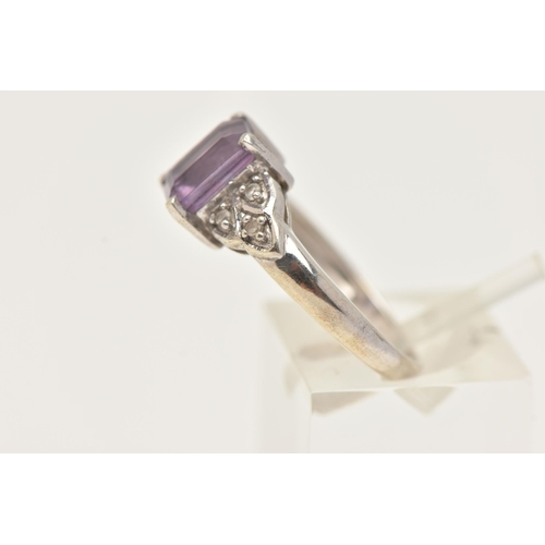 45 - A 9CT WHITE GOLD GEM SET RING, set with a central rectangular cut amethyst, flanked with small circu... 