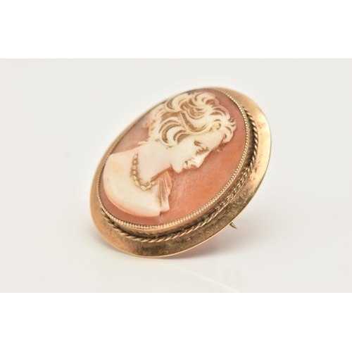 52 - A 9CT GOLD CAMEO BROOCH, of an oval design, set with a carved shell cameo depicting a lady in profil... 