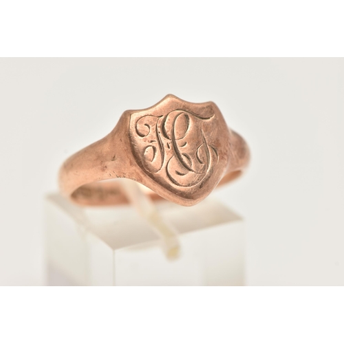 6 - A 9CT GOLD SIGNET RING, a rose tone shield design signet with monogram detail, approximate width 13m... 