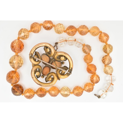 66 - TWO EARLY 20TH CENTURY JEWELLERY ITEMS, to include a faceted Citrine bead necklace, fitted with a wh... 