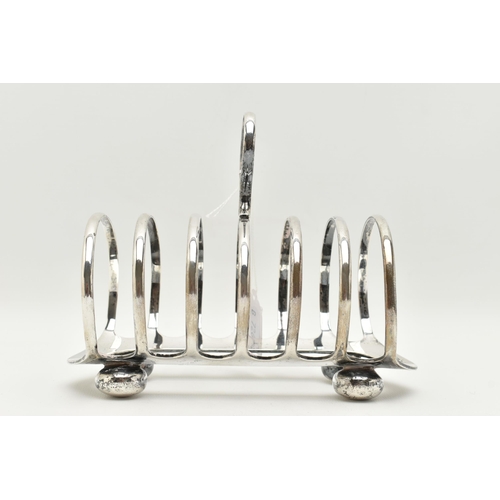 111 - A GEORGE V SILVER TOAST RACK, six slot polished toast rack, on four bun feet with loop handle, hallm... 