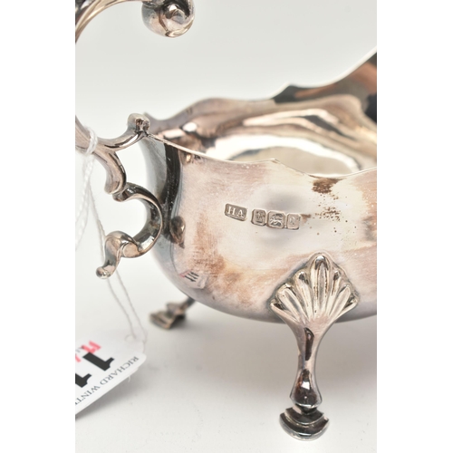 114 - AN EDWARDIAN SILVER GRAVY BOAT, of a polished form with wavy rim, raised on three hoof feet with she... 