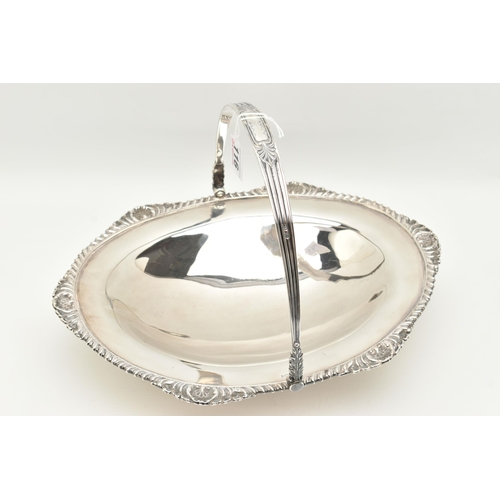 116 - AN EDWARDIAN SILVER FRUIT BASKET, of an oval form gadrooned and shell pattern rim, with handle, on a... 