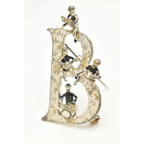 80 - A 'BEATLES' BROOCH,  a large white metal 'B' brooch with four figures playing instruments, signed 'E... 