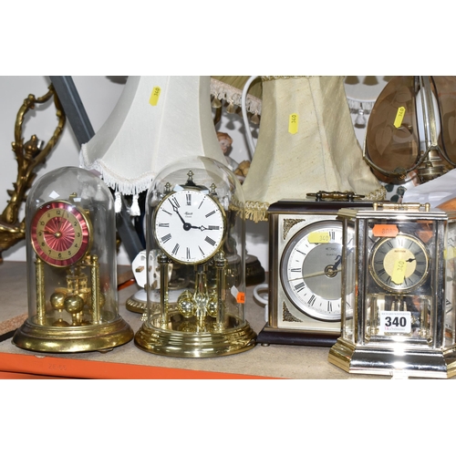 340 - A LARGE QUANTITY OF ASSORTED CLOCKS AND TABLE LAMPS, comprising a modern Swiss made cuckoo clock by ... 