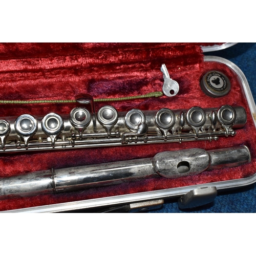 348 - A BOOSEY & HAWKES OF LONDON THREE PIECE FLUTE, comprising a red lined case with original key, serial... 