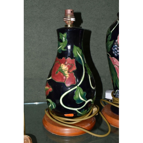 359 - TWO ANNIE ROWE COUNTRY CRAFT COLLECTION TABLE LAMPS, tube lined with flowers and fruit on navy blue ... 