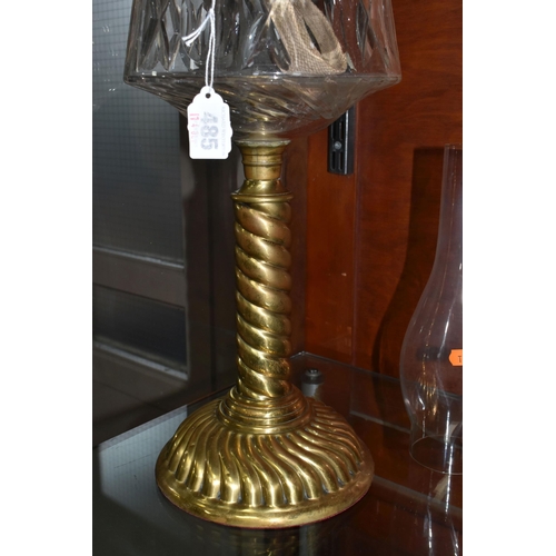 485 - A CUT GLASS AND BRASS OIL LAMP, with cut glass reservoir, brass twist column and base, etched shade ... 