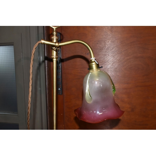 487 - A BRASS RISE AND FALL TABLE LAMP, with cranberry and uranium glass shade, with frilled rim and appli... 