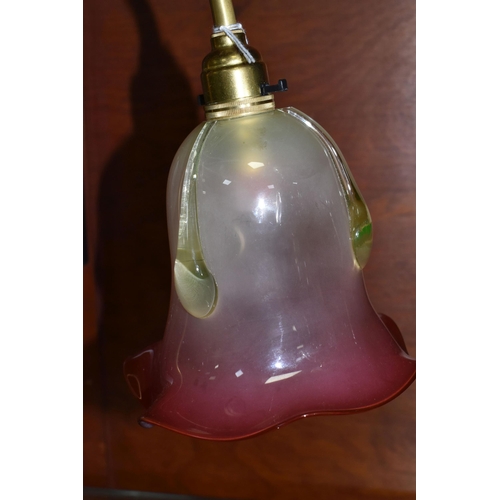 487 - A BRASS RISE AND FALL TABLE LAMP, with cranberry and uranium glass shade, with frilled rim and appli... 