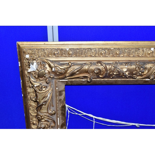 517 - A LARGE DECORATIVE MOULDED PICTURE FRAME, bears an attribution plaque for Pietro Toretti ( 1888-1927... 