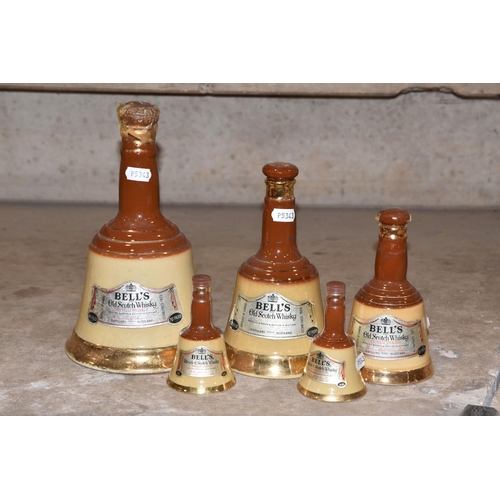 945 - BELL'S WHISKY, Five Bell's Whisky Wade Decanters in descending order of size from 26 2/3 fl.oz.,cont... 