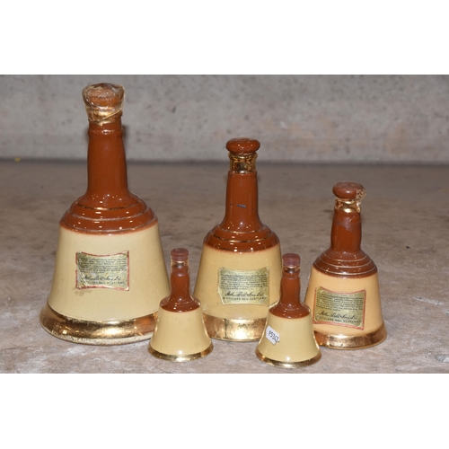 945 - BELL'S WHISKY, Five Bell's Whisky Wade Decanters in descending order of size from 26 2/3 fl.oz.,cont... 