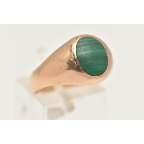 13 - A MALACHITE SIGNET RING, designed as an oval malachite cabochon to the tapered band, stamped 375, ri... 