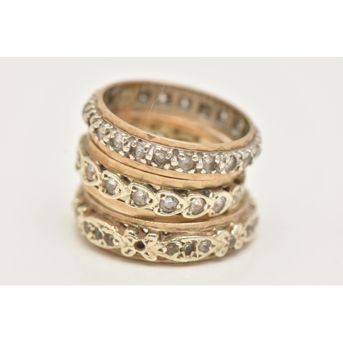 27 - THREE YELLOW METAL FULL SET ETERNITY BAND RINGS, each set with colourless spinel's, one stamped 9.37... 