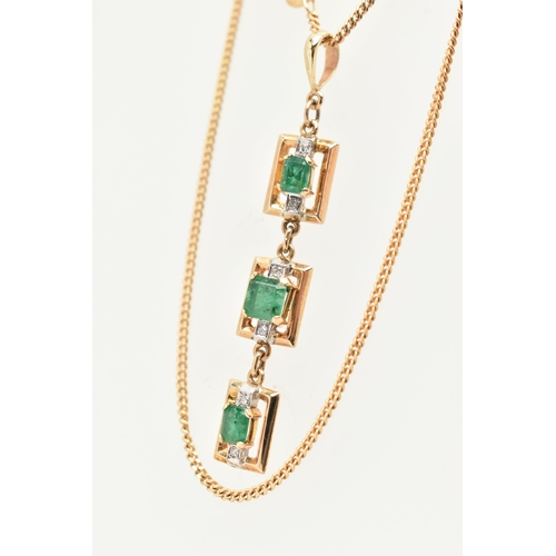 50 - A YELLOW METAL AND EMERALD NECKLACE, designed as three rectangular open work panels, two set with an... 