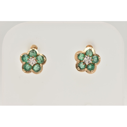 51 - A PAIR OF GEM SET EARRINGS, designed as a yellow metal flower, each prong set with five circular cut... 