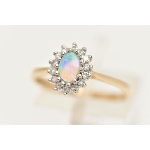 58 - A 9CT GOLD OPAL AND DIAMOND CLUSTER, an oval opal, prong set with a surround of round brilliant cut ... 