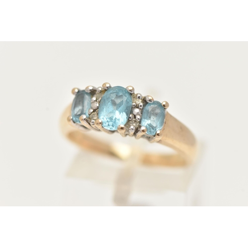 59 - A 9CT GOLD GEM SET RING, three oval cut topaz, and four single cut diamonds, prong set in yellow gol... 