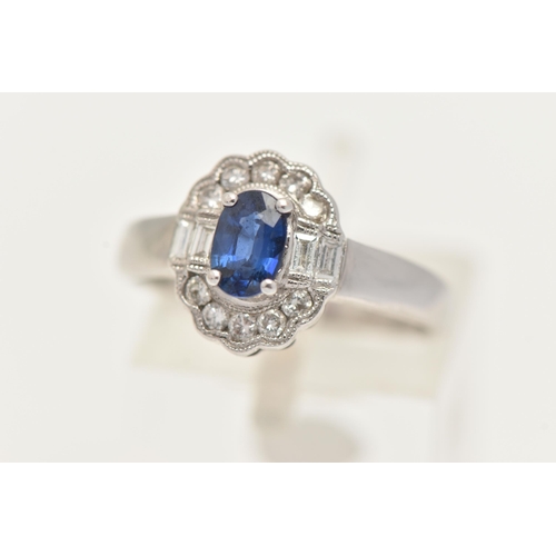 60 - A WHITE METAL GEM SET RING, a principally set oval cut blue sapphire, set with a surround of ten rou... 