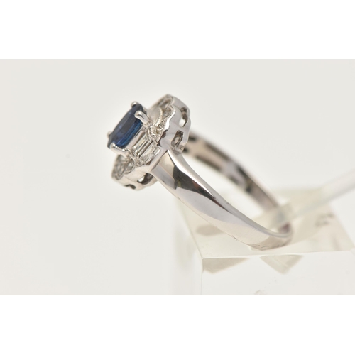 60 - A WHITE METAL GEM SET RING, a principally set oval cut blue sapphire, set with a surround of ten rou... 