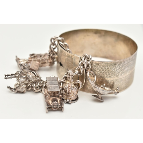 81 - A WHITE METAL CHARM BRACELET AND BANGLE, the charm bracelet suspending eight charms from a curb link... 