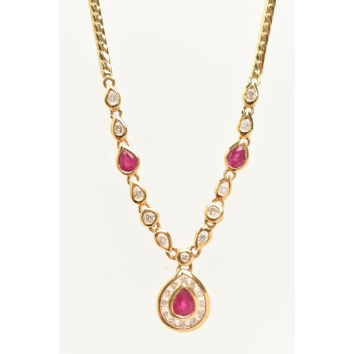 121 - AN 18CT YELLOW GOLD RUBY AND DIAMOND NECKLACE, the pendant fitted with a pear cut dropper set with a... 