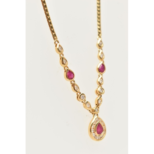 121 - AN 18CT YELLOW GOLD RUBY AND DIAMOND NECKLACE, the pendant fitted with a pear cut dropper set with a... 