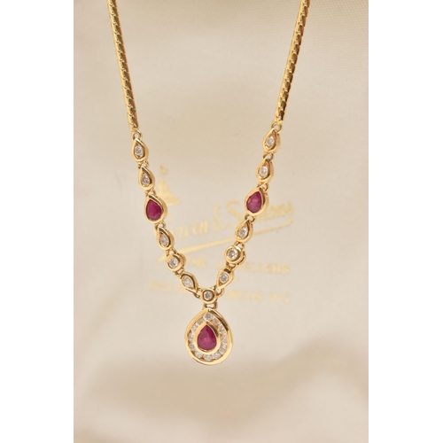 121 - AN 18CT YELLOW GOLD RUBY AND DIAMOND NECKLACE, the pendant fitted with a pear cut dropper set with a... 