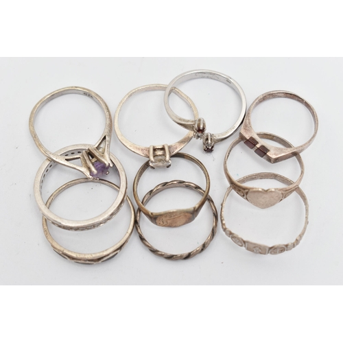 138 - TEN WHITE METAL RINGS, of various designs and sizes, some stamped 925, silver, some unmarked metal (... 