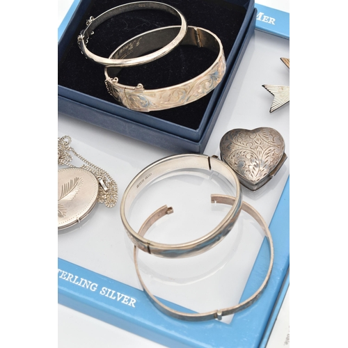 156 - A SELECTION OF SILVER AND WHITE METAL JEWELLERY, to include four hinged bangles, four lockets, a hea... 