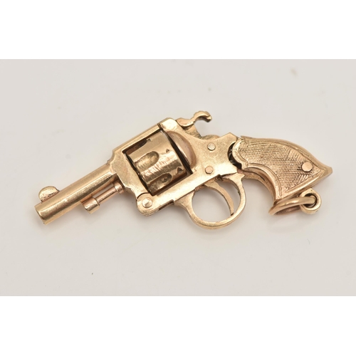 85 - A 9CT GOLD WATCH KEY FOB, in the form of a magnum gun, rotating barrel and moving parts, fitted with... 