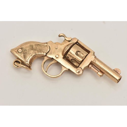 85 - A 9CT GOLD WATCH KEY FOB, in the form of a magnum gun, rotating barrel and moving parts, fitted with... 