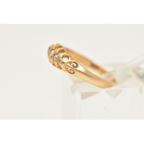 86 - AN 18CT GOLD DIAMOND RING, set with five graduated old cut diamonds, scrolls to the shoulders leadin... 