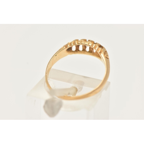 86 - AN 18CT GOLD DIAMOND RING, set with five graduated old cut diamonds, scrolls to the shoulders leadin... 