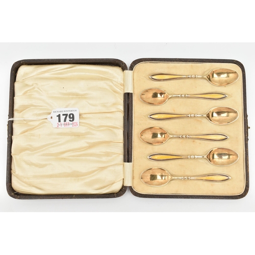 179 - A CASED SET OF SIX EARLY 20TH CENTURY SILVER GILT AND ENAMEL TEAPSOONS, each spoon decorated with a ... 
