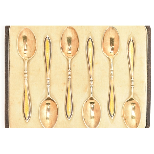 179 - A CASED SET OF SIX EARLY 20TH CENTURY SILVER GILT AND ENAMEL TEAPSOONS, each spoon decorated with a ... 