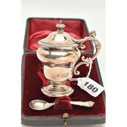 180 - A CASED LATE VICTORIAN SILVER MUSTARD WITH SPOON, urn shape mustard fitted with a scrolling handle a... 