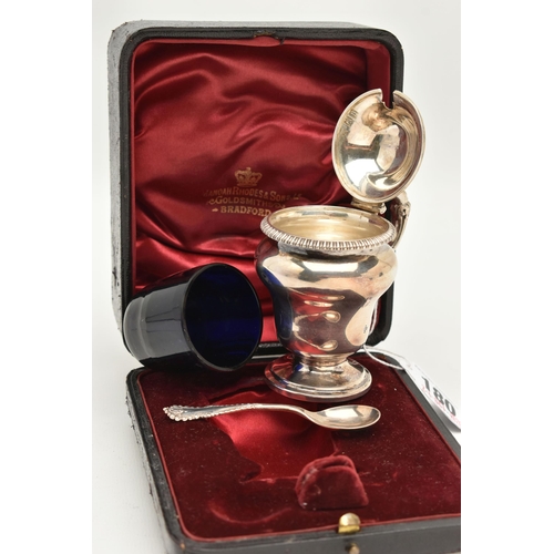 180 - A CASED LATE VICTORIAN SILVER MUSTARD WITH SPOON, urn shape mustard fitted with a scrolling handle a... 