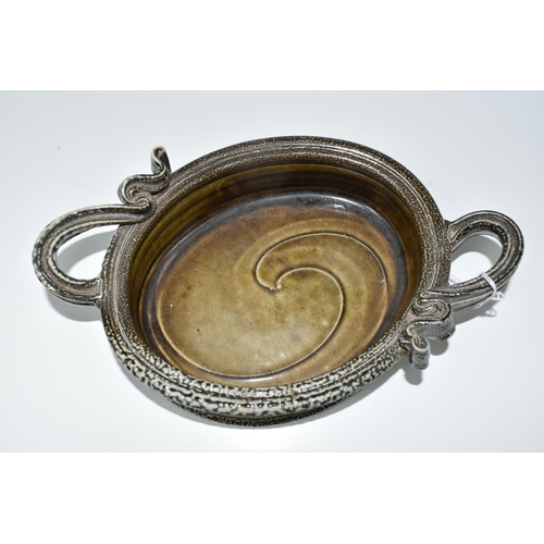 415 - WALTER KEELER (1942): A SALT GLAZED STONEWARE DISH, the oval dish with twin ribbon-style handles, an... 