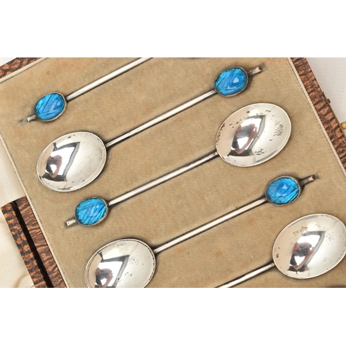 912A - A CASED SET OF SIX EARLY 20TH CENTURY SILVER COFFEE SPOONS, each spoon set with a blue guilloche ena... 