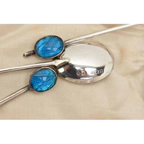 912A - A CASED SET OF SIX EARLY 20TH CENTURY SILVER COFFEE SPOONS, each spoon set with a blue guilloche ena... 