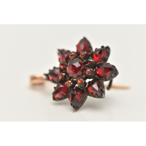 923A - A BOHEMIAN GARNET CONVERSION BROOCH, designed as a flower set in a white metal mount, fitted with a ... 