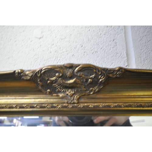 1202 - A LARGE RECTANGULAR GILT FRAME BEVELLED EDGE WALL MIRROR, with foliate decorations, 133cm x 107cm (c... 